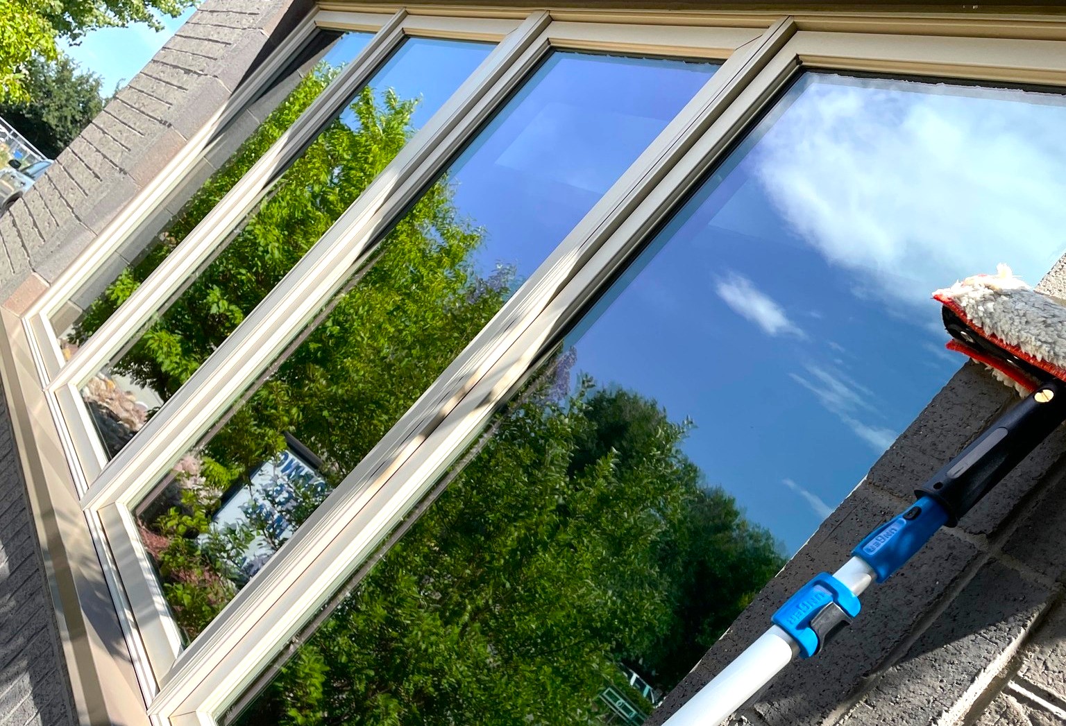 Reflective commercial-style windows being cleaned