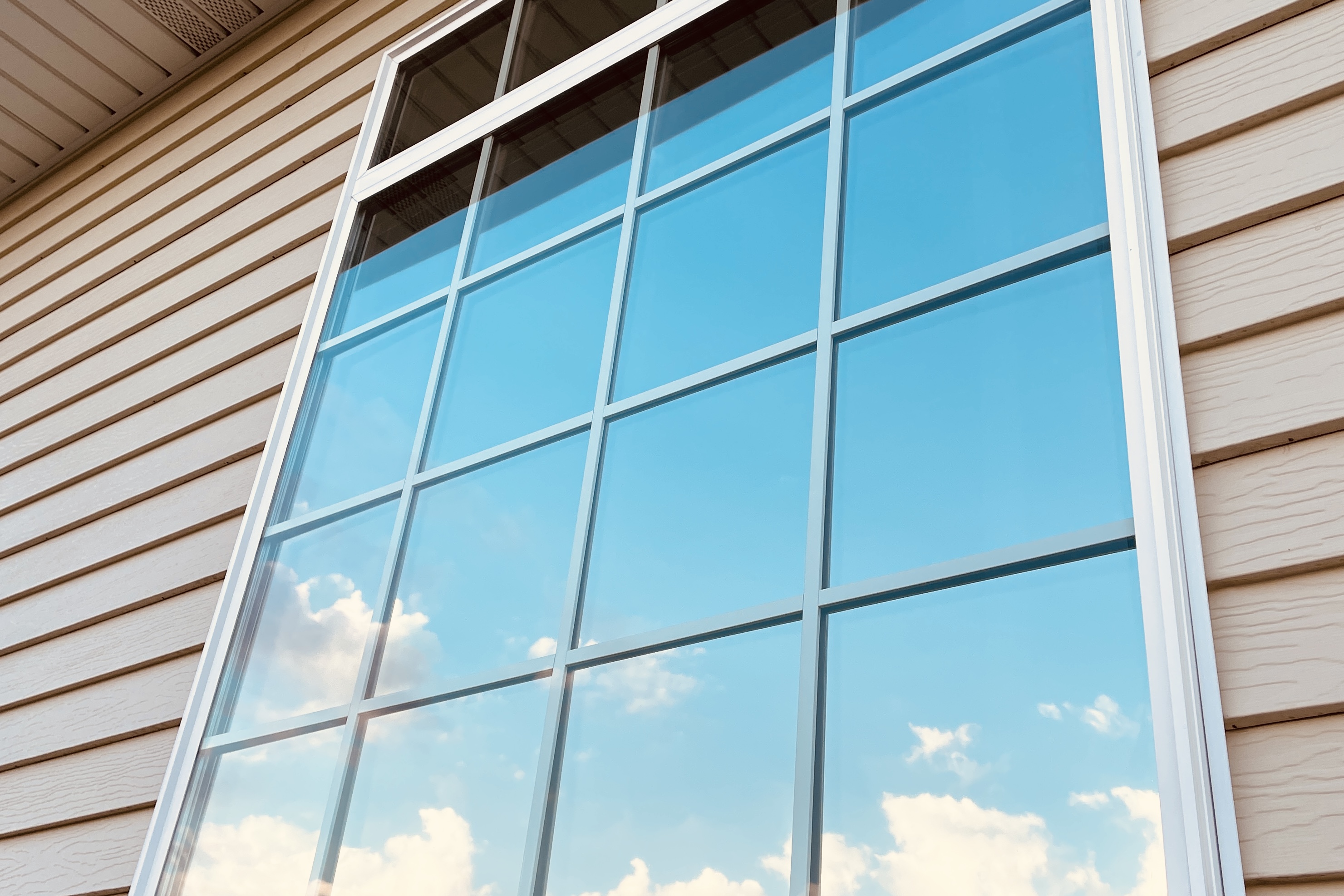 Bright, clear residential window looking out to blue skies